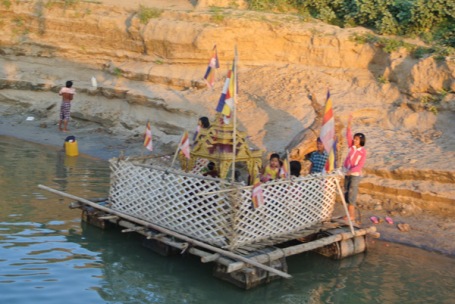 Children playing on a floating shrine