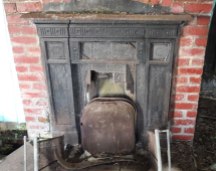 Fireplace and red brick mantlepiece in an abandoned chapel / building, Bedlam