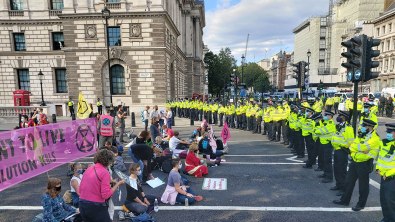 Protesters sit in street of Parliament Square in front of police line